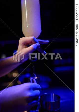 The Art of Crafting Unique Cocktails in a Cozy, Dimly Lit, and Inviting Bar Environment 122244581