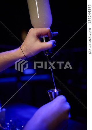 The Art of Crafting Unique Cocktails in a Cozy, Dimly Lit, and Inviting Bar Environment 122244583