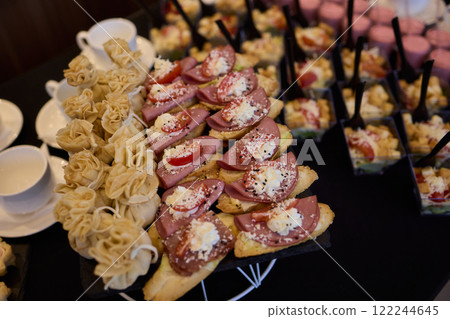 An Elegant Assortment of Gourmet Desserts and Savory Snacks Beautifully Arranged on Table 122244645
