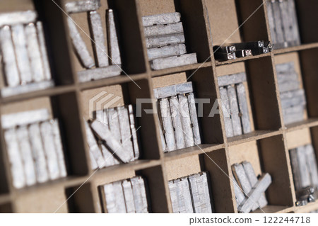 Closeup of vintage metal printing blocks in a drawer Closeup of vintage metal printing blocks in a drawer 122244718