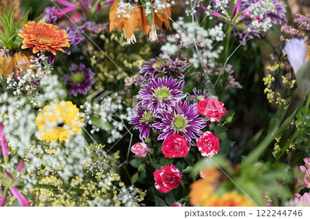 Colorful floral mix featuring purple and red blooms Colorful floral mix featuring purple and red blooms 122244746