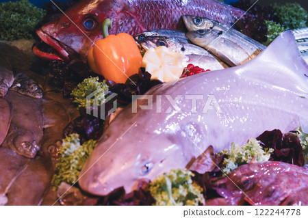 Fresh fish variety on ice at a seafood market 122244778