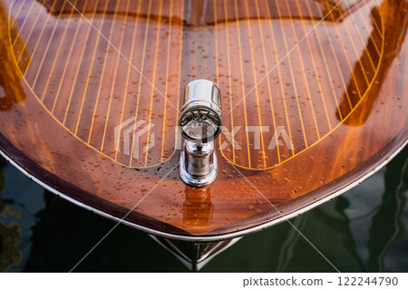 Glossy wooden boat deck with chrome light fixture 122244790