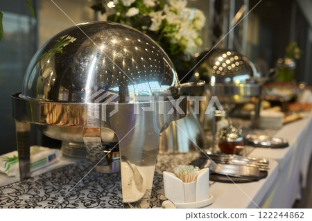 Discover Elegant Buffet Serving Domes Positioned Outside a Stylish Modern Venue Location 122244862