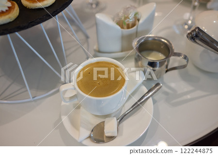 An Elegant Coffee Presentation Accompanied by a Delicious Dessert to Savor and Enjoy 122244875