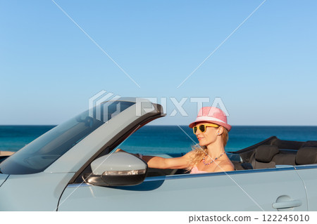 Happy young woman travel by car by the sea Happy young woman travel by car by the sea 122245010