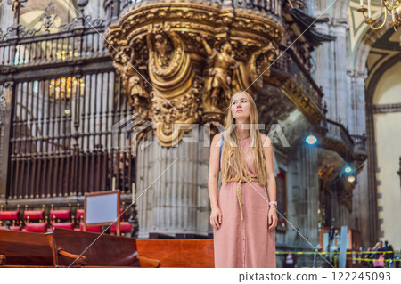 Female tourist exploring the Metropolitan Cathedral in Mexico City. Woman admiring the architecture and history of Mexico's iconic landmark. Concept of cultural heritage, religious tourism, and travel 122245093