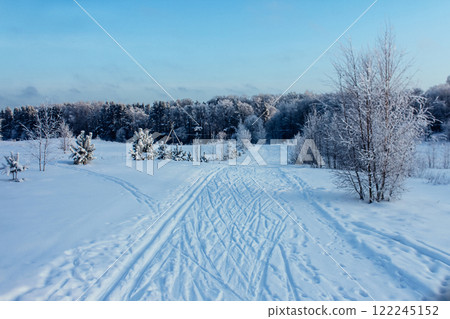 the road through the snow going into the distance. winter landscape the road through the snow going into the distance. winter landscape 122245152