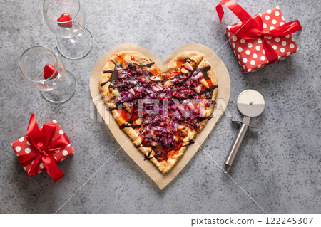 Heart shaped sweet pizza with pineapple on gray background. View from above. Concept of romantic love on Valentine's Day. Heart shaped sweet pizza with pineapple on gray background. View from above. Concept of romantic love on Valentine's Day. 122245307