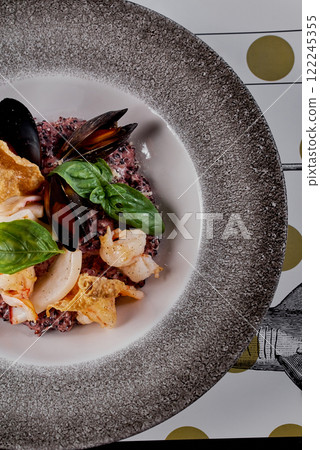 Close-Up of Seafood Risotto with Black Rice and Basil. 122245355