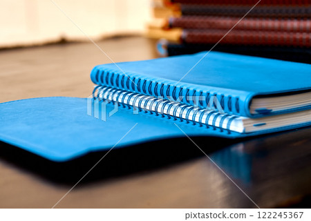 Open Spiral-Bound Blue Notebooks on Wooden Surface. Open Spiral-Bound Blue Notebooks on Wooden Surface. 122245367