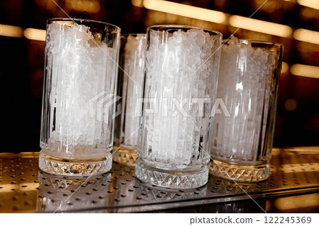 Crystal Glasses Filled with Crushed Ice on a Bar Counter. Crystal Glasses Filled with Crushed Ice on a Bar Counter. 122245369