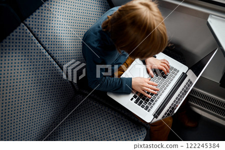 Top View of Boy Typing on Laptop. Top View of Boy Typing on Laptop. 122245384