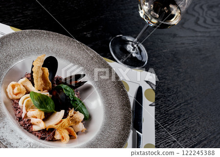 Seafood Risotto with Black Rice and Basil Garnish. Seafood Risotto with Black Rice and Basil Garnish. 122245388