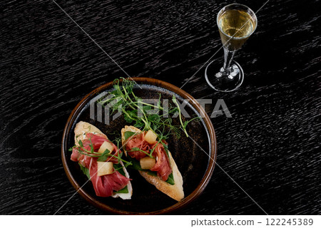 Prosciutto Crostini with Pear and Microgreens. 122245389
