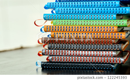 Colorful Stack of Leather-Bound Notebooks with Spiral Bindings. 122245393