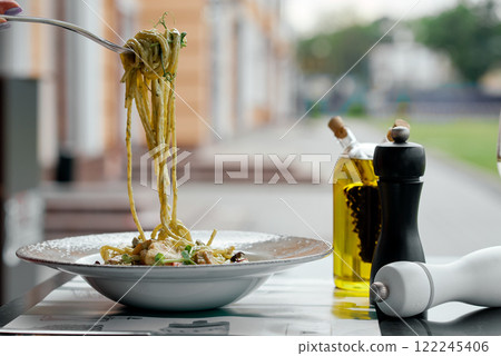 Fork Twirling Pesto Pasta Close-Up. 122245406