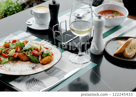 Fresh Salad with Cappuccino and Wine Glass. 122245433