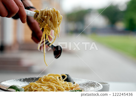 Hands Lifting Creamy Seafood Spaghetti. 122245436