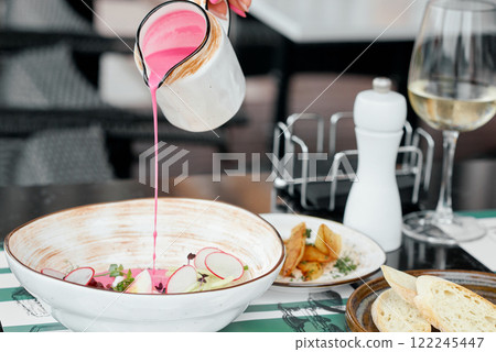 Pouring Beetroot Soup into Ceramic Bowl. Pouring Beetroot Soup into Ceramic Bowl. 122245447