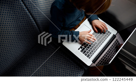 Close-Up of Hands Typing on Laptop. 122245449