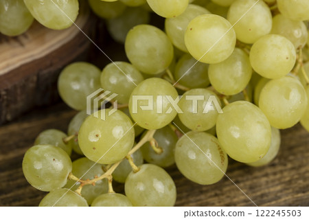 a large number of ripe green grapes are on the table 122245503