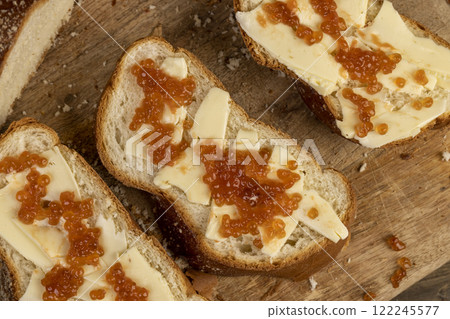 a soft loaf of wheat flour with butter and red salmon caviar 122245577