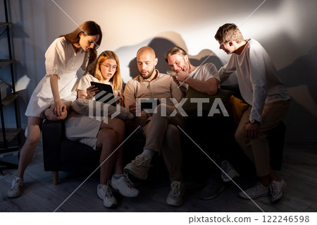 Discussion photo. Studio cooperation. Team photographers models review shoot results. Friendly communication colleagues project ideas. 122246598