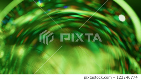 Blurred stroboscope. Strobe rotation. Rays pass through round faceted lens. Bright green twinkle. Refracting effect background. Colorful festive shimmer. Blurred stroboscope. Strobe rotation. Rays pass through round faceted lens. Bright green twinkle. Refracting effect background. Colorful festive shimmer. 122246774