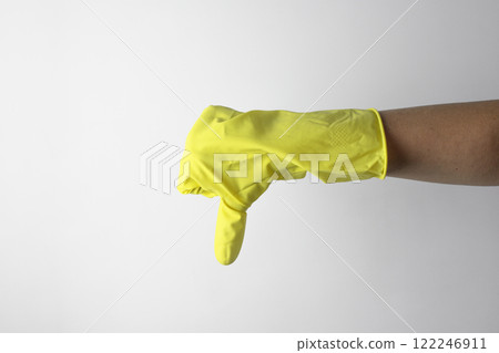 Housekeeping concept. Hand in yellow glove showing bad sign 122246911