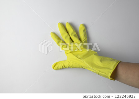 Housekeeping concept. A hand in a yellow glove for cleaning Housekeeping concept. A hand in a yellow glove for cleaning 122246922