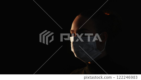 Quarantine silhouette. Covid protection. Respiratory disease. Dark outline of sick woman wearing face mask isolated on black copy space background. Quarantine silhouette. Covid protection. Respiratory disease. Dark outline of sick woman wearing face mask isolated on black copy space background. 122246983