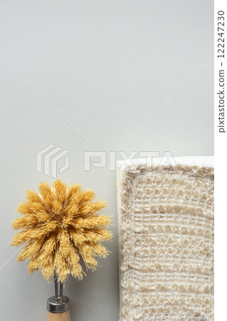 Tableware brush and kitchen cellulose sponge close-up. Eco-friendly lifestyle concept, vertical Tableware brush and kitchen cellulose sponge close-up. Eco-friendly lifestyle concept, vertical 122247230