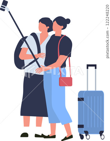 Two female tourists are taking a selfie with selfie stick while waiting for boarding at airport terminal, trolley suitcase is standing next to them 122248220