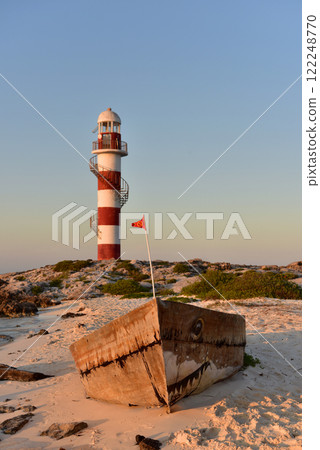 Lighthouse on a rocky shore in Cancun. Clear sky and blue sea. Mexico. 122248770