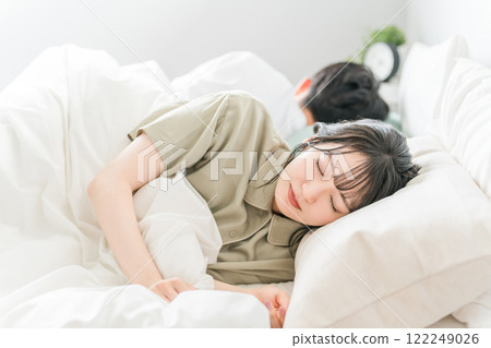 A young couple sleeping in bed (good sleep, sound sleep, deep sleep) A young couple sleeping in bed (good sleep, sound sleep, deep sleep) 122249026