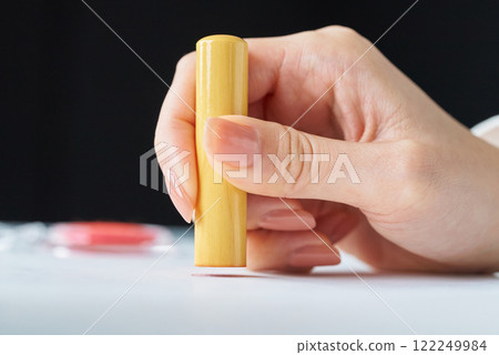 Hand stamping a seal 122249984