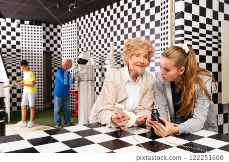 Grandparents and grandkids in escape room Grandparents and grandkids in escape room 122251600