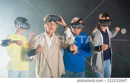 Grandparents and grandkids playing VR games together 122251647