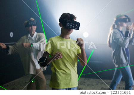 Family are wearing virtual reality goggles in quest room Family are wearing virtual reality goggles in quest room 122251691
