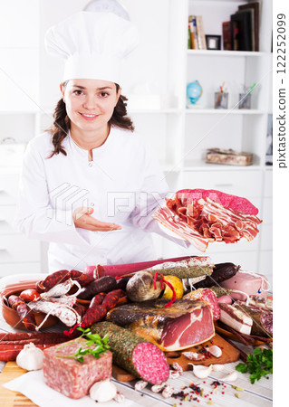 Cook woman with smoked products 122252099