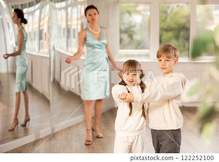 Boy and girl in sport wear train to dance contemporary vigorous rumba during classes. Boy and girl in sport wear train to dance contemporary vigorous rumba during classes. 122252100