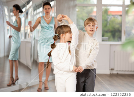Boy with girl dressed in sport wear train to dance waltz during classes. Boy with girl dressed in sport wear train to dance waltz during classes. 122252226