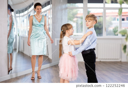Boy and girl in pair train to dance contemporary vigorous waltz during classes. Boy and girl in pair train to dance contemporary vigorous waltz during classes. 122252246
