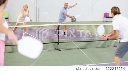Man and woman training to play pickleball tennis on the pickleball cour 122252254