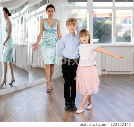 Boy and girl in pair train to dance contemporary vigorous hustle during classes. Boy and girl in pair train to dance contemporary vigorous hustle during classes. 122252342