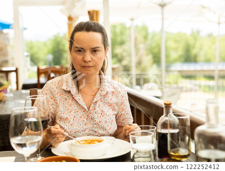 Portrait of woman having lunch gazpacho traditional dish of Spanish cuisine 122252412