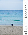 一個女人看著平靜的藍色大海 122252720