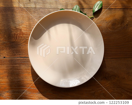 white plate on wooden table white plate on wooden table 122253109