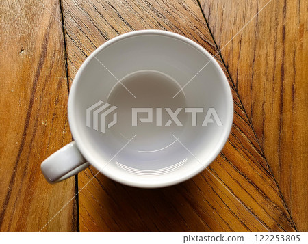 White cup on a wooden table 122253805